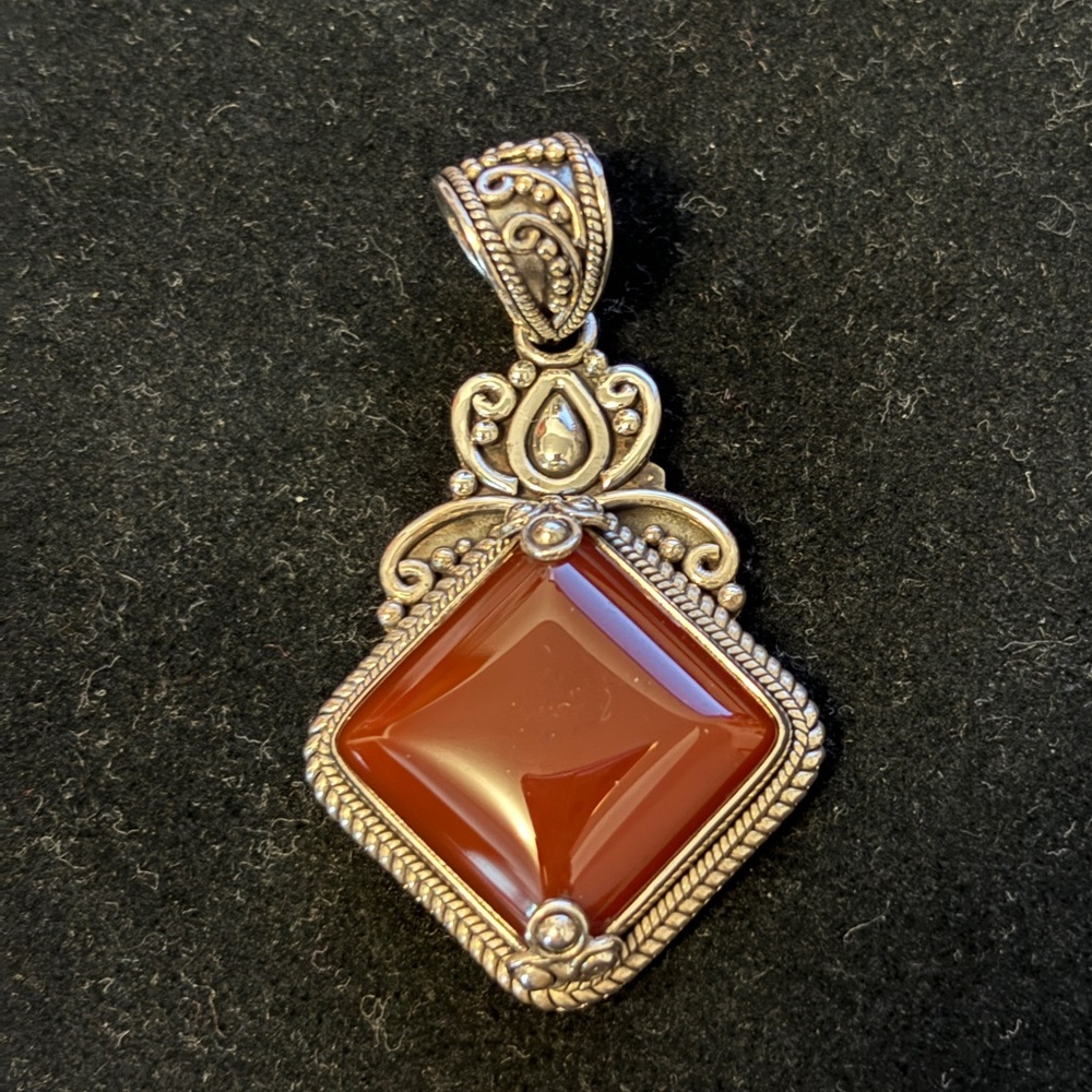 Sterling silver pendant with brown/red colored stone